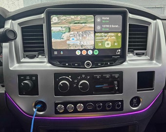 May include: A car dashboard with a touchscreen display showing a map and music controls. The display shows the song "Wild Ones (Extended Mix)" by Jessie Murphy & Jelly. The dashboard also has a USB port and a row of buttons.