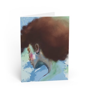 May include: Greeting card featuring an artistic illustration of a person with brown hair and a side profile. The artwork uses a soft color palette of blues, greens, and pinks. The word "Muse" is written vertically on the left side of the card.