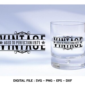 May include: A clear glass with the text "Vintage Aged to Perfection 1971" printed on the side. The glass is sitting on a white surface.