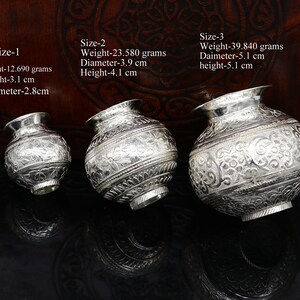 May include: Three silver decorative bowls of varying sizes. The bowls are intricately engraved with floral patterns. The bowls are labelled with their size and measurements in grams and centimetres.
