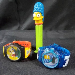 The Simpsons, two watches and a pez dispenser