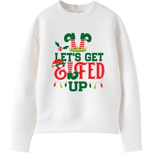 May include: White Christmas sweatshirt with a green and red elf design and the text "Let's Get Elfed Up".