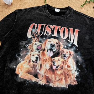 May include: Black t-shirt with a graphic print of five golden retriever dogs with the word "CUSTOM" in red and white letters.