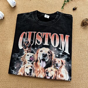 May include: Black t-shirt with a graphic print of multiple golden retriever dogs and the word "CUSTOM" in a red and orange gradient.