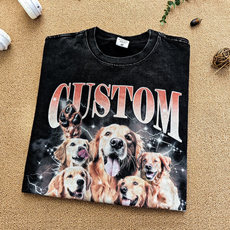 May include: Black t-shirt with a graphic print of multiple golden retriever dogs and the word "CUSTOM" in a red and orange gradient.