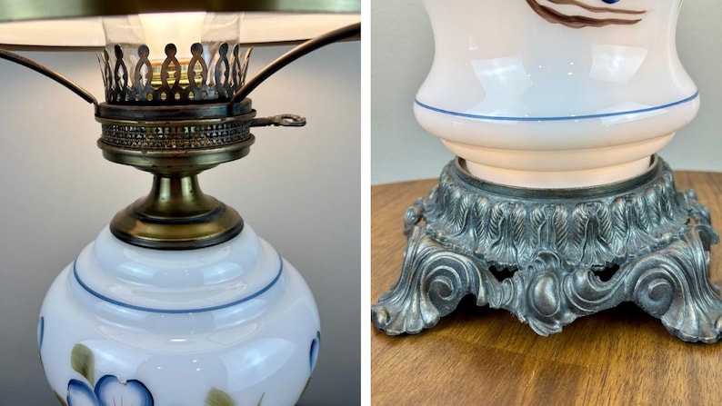 May include: A white ceramic lamp with blue floral designs and a gold metal base. The lamp has a clear glass shade and a metal finial.