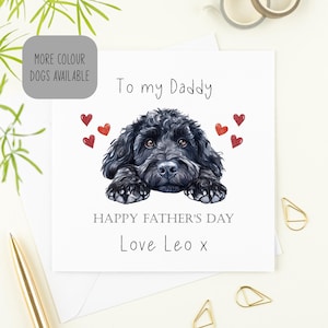 May include: A Father's Day card with a black dog illustration. The card reads "To my Daddy", "Happy Father's Day", and "Love Leo x". Red heart accents surround the dog. A grey box says "More colour dogs available".