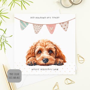 May include: A square birthday card with a watercolour illustration of a brown dog. The card reads "DID SOMEONE SAY CAKE?" above the dog and "HAPPY BIRTHAY SAM" below. The design includes bunting and polka dots, creating a charming and celebratory feel.