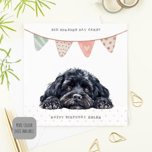 May include: A birthday card with a black dog illustration. The card reads "DID SOMEONE SAY CAKE?" and "HAPPY BIRTHDAY HELEN". The design includes watercolour bunting across the top. The card is square.
