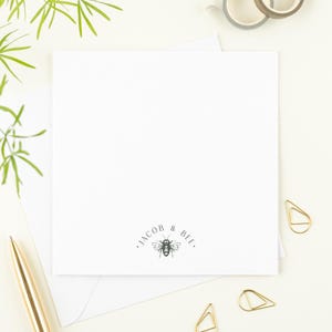 May include: A white card with a bee illustration and the text "JACOB & BIE."