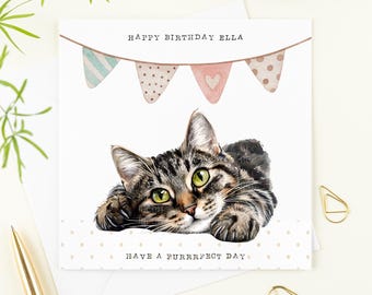 May include: A square birthday greeting card featuring a watercolor illustration of a brown tabby cat lying down. Above the cat is a string of pastel bunting flags. The text reads HAPPY BIRTHDAY ELLA and HAVE A PURRRFECT DAY.