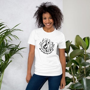 May include: White t-shirt with a black graphic of stylised flowers and the text "gardening mama".