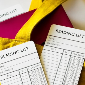 Two paper bookmarks that say Reading List and have room for the reader's name, the date and the titles of the books they've read, plus a review out of 5-stars.