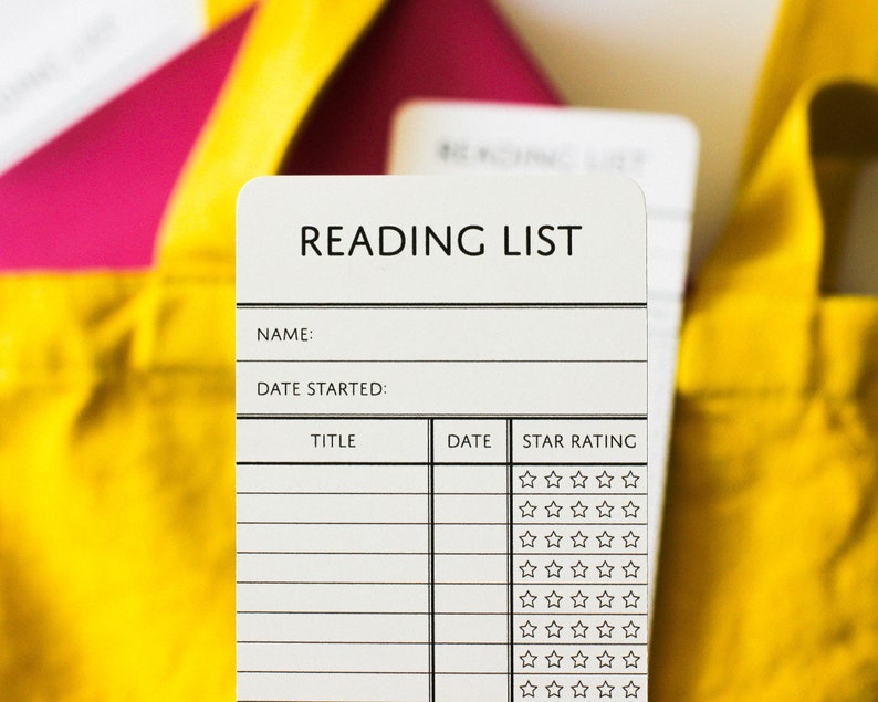 Close up of a paper bookmarks that say Reading List and has room for the reader's name, the date, and the titles of the books they've read, plus a review of each book out of 5-stars.