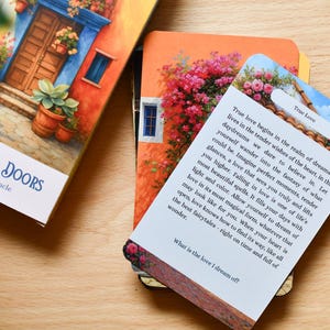 May include: An oracle deck titled "Enchanted Doors" and a card with the words "True Love". The deck features colourful illustrations of doors and flowers. The card has text about love and dreams.