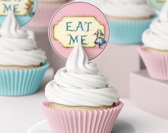 May include: Cupcakes with white frosting and pink, blue, and purple cupcake liners. Each cupcake has a decorative topper with the words "EAT ME" and an illustration of Alice from Alice in Wonderland.