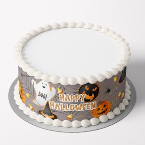 May include: A round cake decorated with a gray and orange edible image featuring a ghost, witch's hat, pumpkins, and the text "Happy Halloween".