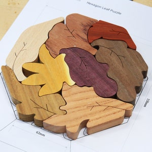 May include: A wooden hexagon leaf puzzle with six pieces, each a different color and shape. The puzzle measures 6.2 inches by 7.5 inches.