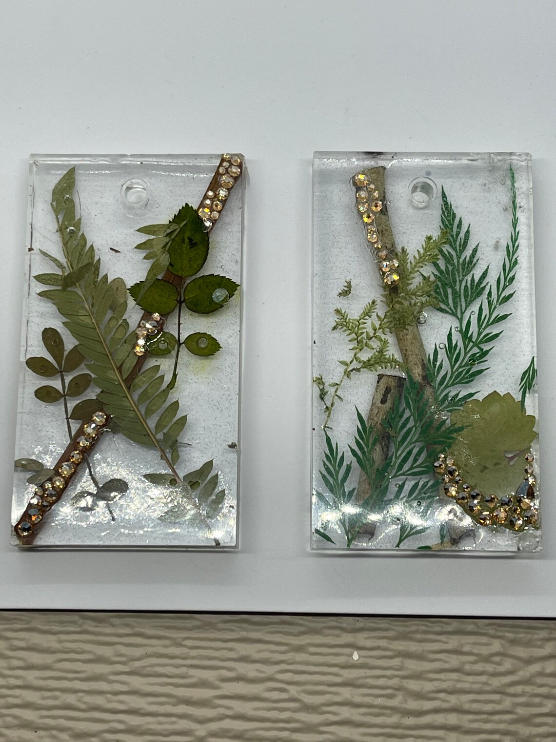 Epoxy resin pendant made with dry leaves and sticks. Few Etsy
