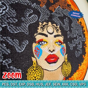 May include: Embroidered portrait of a woman with a large afro. The face features colorful makeup, including red lips and blue and red tear-shaped designs. Gold earrings and a circular design around the face are also visible. The word "ZOOM" is at the bottom.