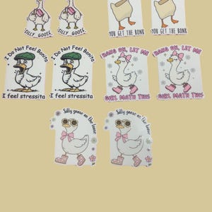 May include: A collection of stickers featuring cartoon geese with various phrases. Some stickers say "Certified Silly Goose," while others have text like "Mess with the Honk" and "Girl Math This." The stickers are white with colorful accents.