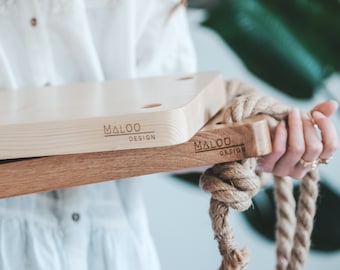 May include: Two wooden swing sets with rope, each with the logo "MALOO DESIGN" engraved on the surface.