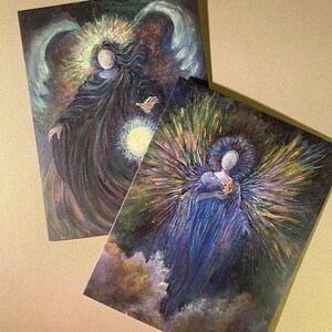 May include: Two angel paintings with a dark background. The first angel is wearing a dark blue robe with a halo of light. The second angel is wearing a purple robe with a halo of light and is surrounded by a burst of light.