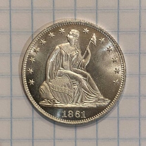 May include: Silver coin with a seated Liberty figure holding a staff and a shield with the word "LIBERTY" inscribed on it. The coin has a border of stars and the date "1861" inscribed below the figure.