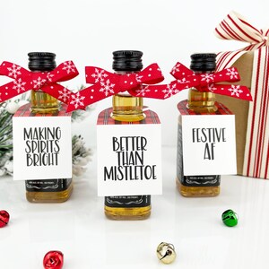 May include: Three miniature liquor bottles with festive Christmas-themed gift tags. The tags read "Making Spirits Bright", "Better Than Mistletoe", and "Festive AF".