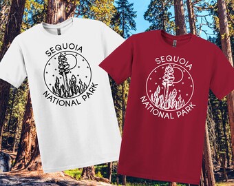 May include: Two short-sleeved t-shirts, one white and one red, each with a circular graphic. The graphic includes the text "SEQUOIA NATIONAL PARK" around a central illustration of a tree and other foliage.
