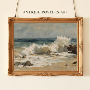 May include: A framed vintage seascape painting with a gold ornate frame. The artwork depicts ocean waves crashing against rocks on a sandy beach. The text "ANTIQUE POSTERS ART" is above the frame.