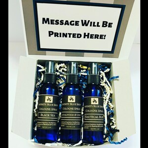 May include: A set of three blue cologne spray bottles in a gift box. The bottles are labeled "Black Sea", "Sandalwood & Citrus", and "Nautical Blue". Each bottle is 2 oz.