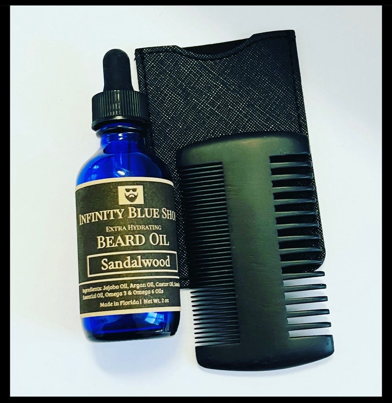 May include: A blue glass bottle of Infinity Blue Shop Extra Hydrating Sandalwood Beard Oil with a black dropper cap, a black comb, and a black textured pouch. The label lists ingredients and a net weight of 2 oz.