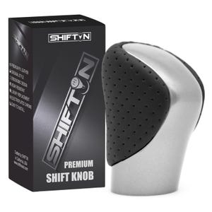 May include: A silver and black gear shift knob with a perforated texture on the sides, positioned next to a black rectangular product box labeled SHIFTIN Premium Shift Knob with listed features including premium PU leather and electroplated chrome.