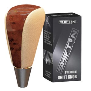 May include: A premium shift knob with a wood grain top and beige sides, and a silver base. The product is packaged in a black box with the text "SHIFT N PREMIUM SHIFT KNOB". The shift knob is made in California, USA.