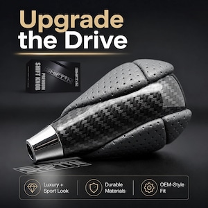 May include: A gear shift knob featuring a combination of black carbon fiber texture and perforated grey leather panels. The base is finished in a polished silver metallic tone. The text "Upgrade the Drive" and "SHIFTIN" are visible in the image.