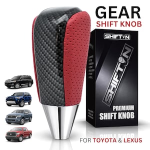 May include: A gear shift knob featuring a black carbon fiber center panel flanked by red perforated leather sides and a silver metallic base. The product is displayed next to its black packaging box labeled SHIFTN PREMIUM SHIFT KNOB FOR TOYOTA & LEXUS.