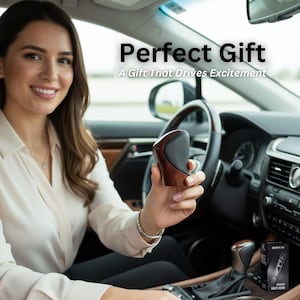 May include: A car interior shot featuring a shift knob with a wood grain finish and black accents. The text "Perfect Gift" and "A Gift That Drives Excitement" are displayed above the shift knob.