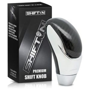May include: A premium shift knob with a black and silver design, next to a black box with the text "SHIFTIN" and product details. The shift knob has a glossy black top and a silver base.