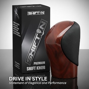 May include: A premium shift knob with a wood grain finish and black accents, next to a black box with the "SHIFTIN" logo. The box also states "DRIVE IN STYLE" and "Statement of Elegance and Performance".