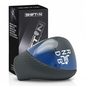May include: A black and blue car shift knob with the text "RND B" in white. The shift knob is next to a black box with the text "SHIFT'N" and product details. The shift knob has a perforated leather grip.