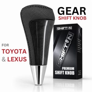 May include: A black gear shift knob with a textured leather top and a glossy dark wood grain center section, featuring a silver metallic base. The product is displayed next to its black packaging box labeled SHIFTON PREMIUM SHIFT KNOB FOR TOYOTA & LEXUS.