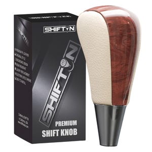 May include: A premium shift knob with a cream-colored leather side and a wood grain finish. The knob has a chrome base and is packaged in a black box with the "SHIFTIN" logo and product details.