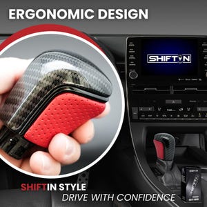 May include: A carbon fiber shift knob with a red perforated leather accent. The knob is held in a hand, with the text "SHIFTIN STYLE" and "DRIVE WITH CONFIDENCE" at the bottom. The text "ERGONOMIC DESIGN" is at the top.