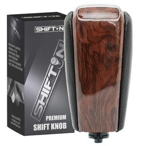 May include: A premium shift knob with a wood grain finish and black leather accents. The product is packaged in a black box with the "SHIFTIN" logo and product details. The shift knob is designed for ergonomic comfort and wear resistance.