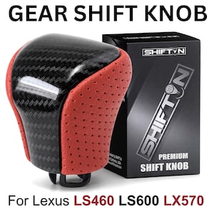 May include: A gear shift knob featuring a black carbon fiber top and perforated red sides. The product is displayed next to a black box labeled SHIFTN PREMIUM SHIFT KNOB. Text at the top reads GEAR SHIFT KNOB and at the bottom For Lexus LS460 LS600 LX570.