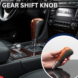 May include: A gear shift knob featuring a polished wood grain top, a textured carbon fiber-style side panel, and a metallic silver base. The knob is shown installed in a vehicle center console and held in a hand in a circular inset image.