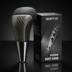 May include: A premium shift knob with a carbon fiber and black leather design. The shift knob has a silver base and is next to a black box with the text "SHIFTN" and "PREMIUM SHIFT KNOB".