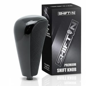 May include: A glossy black shift knob with a textured grip section, next to a black box. The box features the brand name "SHIFT'N" in a silver, angled design, and the words "PREMIUM SHIFT KNOB". The shift knob is a replacement part.