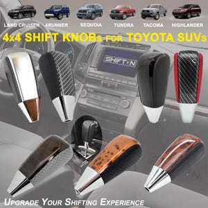 May include: Assortment of 4x4 shift knobs for Toyota SUVs. Knobs feature various designs, including carbon fiber, wood grain, and glossy black finishes. The image includes text that reads "4x4 SHIFT KNOBS FOR TOYOTA SUVS" and "UPGRADE YOUR SHIFTING EXPERIENCE."